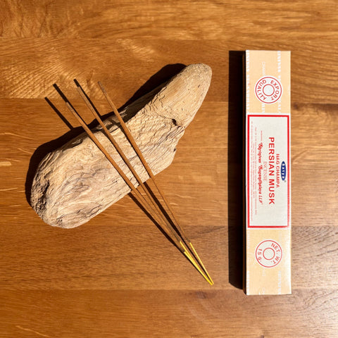 Satya Persian Musk Nag Champa Incense Sticks 15g box on a wooden background, featuring a luxurious and alluring aroma.