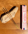 Satya Positive Vibes Incense Sticks 15g box on a wooden background, crafted to uplift and harmonize energy.