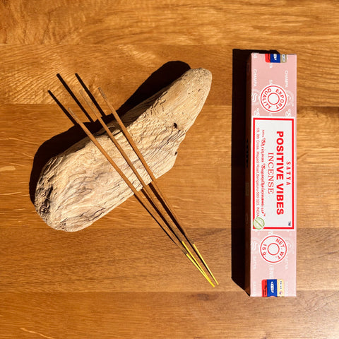 Satya Positive Vibes Incense Sticks 15g box on a wooden background, crafted to uplift and harmonize energy.