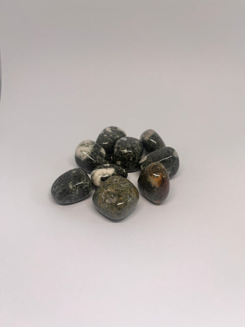 Preseli Bluestone Tumbled Stones showcasing smooth, polished crystals in green and gray hues with unique natural patterns, known for their ancient energy, grounding properties, and ability to enhance spiritual connection.