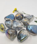 Rainbow Aura Quartz Tumbled Stones displaying smooth, polished crystals with iridescent, multicolored reflections, known for their ability to amplify energy, promote healing, and enhance spiritual connection.