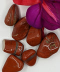 Red and White Jasper Tumbled Stones featuring smooth, polished crystals with vibrant red and contrasting white bands, known for their grounding and balancing energy, ideal for emotional healing.