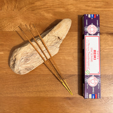 Satya Reiki Incense Sticks 15g box on a wooden background, designed to support energy healing and balance.