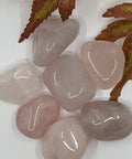 Rose Quartz Tumbled Stones in soft pink hues, showcasing their smooth, polished surfaces.