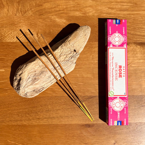 Satya Rose Incense Sticks 15g box on a wooden background, offering a classic and romantic floral fragrance.