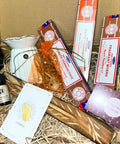 Sacred Comfort Gift Box with three satya fragrances, citrine stone, lemongrass oil, oil burner and incense holder.