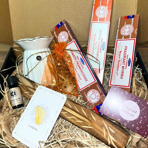 Sacred Comfort Gift Box with three satya fragrances, citrine stone, lemongrass oil, oil burner and incense holder.