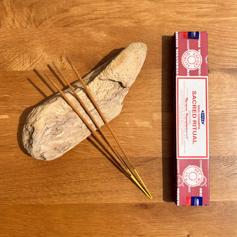 Satya Sacred Ritual Nag Champa Incense Sticks 15g box on a wooden background, perfect for elevating spiritual practices.