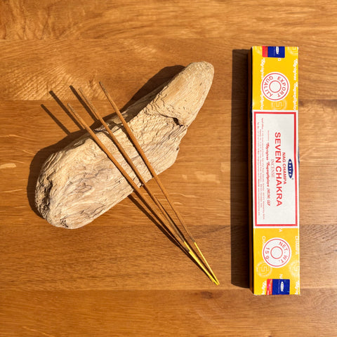 Satya Seven Chakra Nag Champa Incense Sticks 15g box on a wooden background, crafted for chakra alignment and balance.