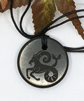 Shungite Capricorn zodiac sign pendant necklace on a white background, for grounding and resilience.