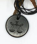 Shungite Libra zodiac sign pendant necklace on a white background, for balance and harmony.