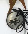 Shungite Sagittarius zodiac sign pendant necklace on a white background, for optimism and focus.