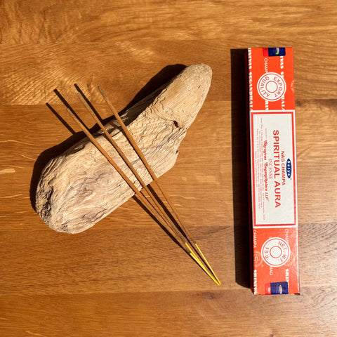 Satya Spiritual Aura Nag Champa Incense Sticks 15g box on a wooden background, designed to promote peace and clarity.