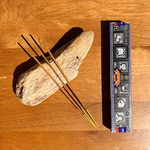 Satya Super Hit Incense Sticks 15g box on a wooden background, featuring a popular aroma for balance and meditation.