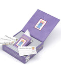 Open box of 'The Original Angel Cards' displaying cards with words like Authenticity, Abundance, and Acceptance, featuring colorful designs.