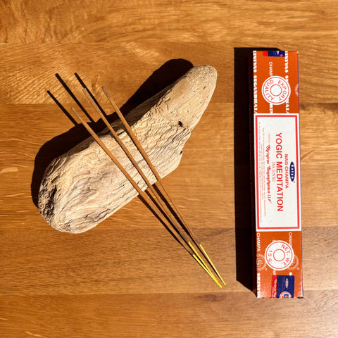 Satya Yogic Meditation Incense Sticks 15g box on a wooden background, designed to support deep meditation.