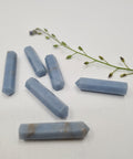 Angelite crystal point with soft blue tones symbolising peace, clarity, and spiritual connection. Associated with the Throat, Third Eye, and Crown Chakras.