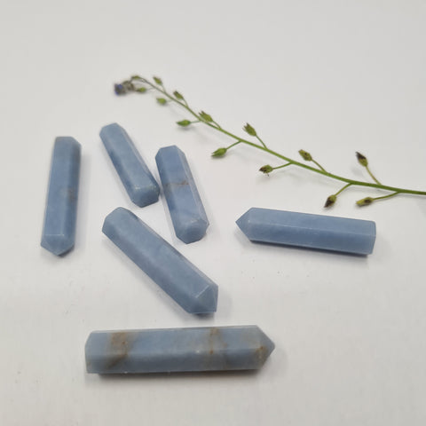 Angelite crystal point with soft blue tones symbolising peace, clarity, and spiritual connection. Associated with the Throat, Third Eye, and Crown Chakras.