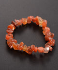 Carnelian Chip Bracelet — image of a stretch bracelet made of natural orange-red carnelian crystal chips, known for boosting confidence, creativity, and passion.