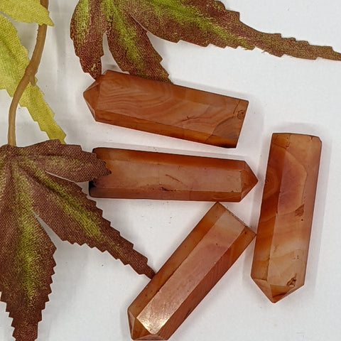 Carnelian crystal point with warm orange tones symbolising passion, motivation, and inner strength. Associated with the Sacral Chakra for creativity and confidence.
