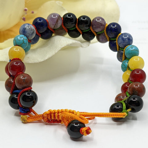 Chakra Super Powerball Bracelet with polished gemstone beads on a white background.