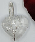 Clear Quartz Heart Pendant featuring a Tree of Life design on a white background.