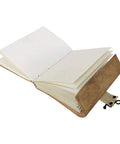 Embossed leather journal open showing handmade natural shade pages for writing and reflection