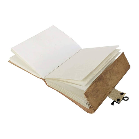 Embossed leather journal open showing handmade natural shade pages for writing and reflection