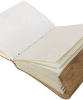 Embossed leather journal open showing handmade natural shade pages for writing and reflection