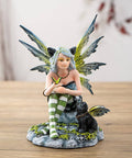 Fairy with Black Cat resin statue featuring a seated fairy with detailed wings and striped stockings, symbolizing magic, intuition, and companionship.