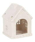 White ceramic gingerbread house candle holder open back