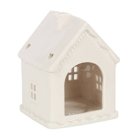White ceramic gingerbread house candle holder open back