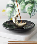 Moon Ceramic Incense Stick Holder displayed on a table with incense burning.