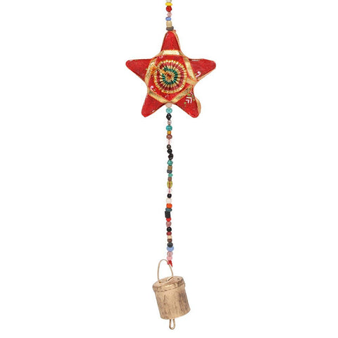 Close-up of red star and small bell detail at bottom of hanging decoration.