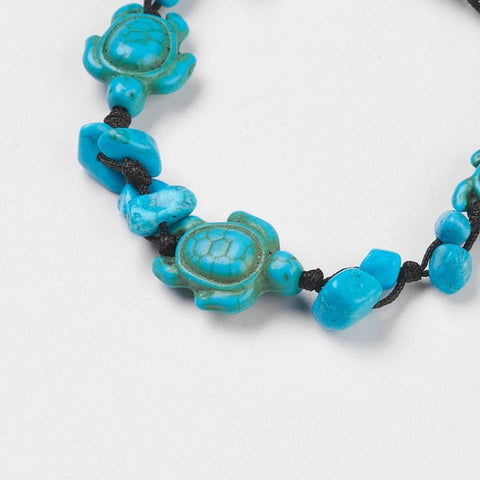 Detail of Blue Howlite chip and turtle thread bracelet symbolising calm, protection, and wisdom. Adjustable cord design associated with the Throat Chakra.