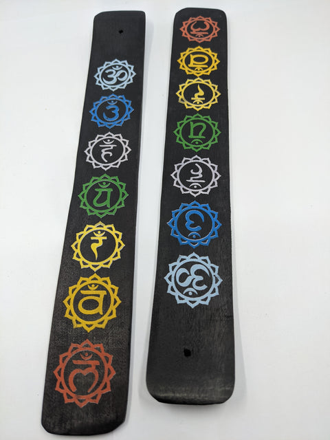 Black Chakra Incense Burner with chakra symbols on a black base, designed for holding incense sticks.