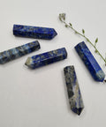 Lapis Lazuli crystal point with deep blue and gold flecks symbolising wisdom, intuition, and clear communication. Associated with the Third Eye and Throat Chakras.
