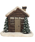 Front view of rustic log cabin incense burner with snow and trees.