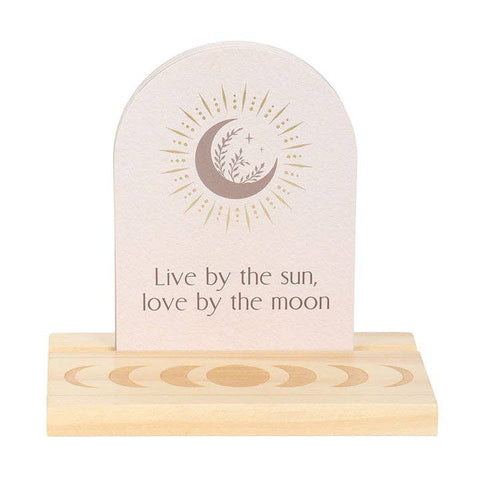 Luna Moth Affirmation Card with message “Live by the sun, love by the moon” on wooden moon phase stand.