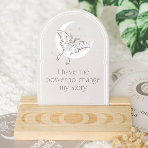 Luna Moth Affirmation Card displayed on wooden moon phase stand with the message “I have the power to change my story.”