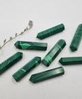 Malachite crystal point with rich green patterns symbolising protection, transformation, and emotional balance. Associated with the Heart Chakra and signs Taurus, Capricorn, Libra, and Scorpio.