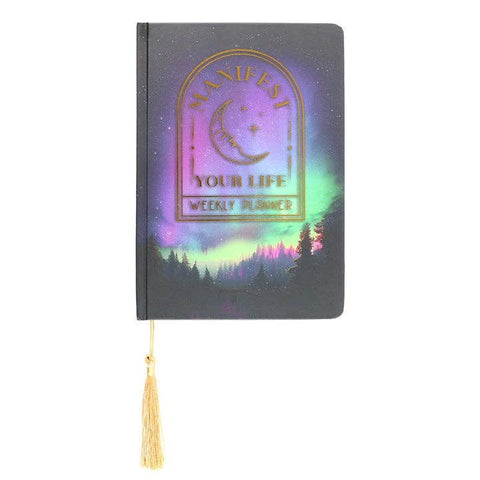 Front view of Manifest Your Life A5 Planner featuring forest night sky and gold lettering.