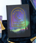 Manifest Your Life Weekly A5 Planner on desk with celestial design and gold foil moon.