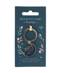 Close-up of Mystical Midnight Hare Keyring on presentation card featuring celestial floral design