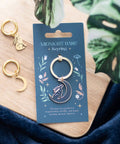 Mystical Midnight Hare Keyring displayed on blue card with gold moon and hare earrings beside it