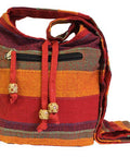 Red nepal sling bag with wide strap and zip pocket in striped woven fabric for everyday use and travel