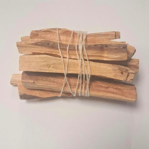 Twelve palo santo holy wood sticks tied with natural twine on white background — Fragrant Heaven Ireland
