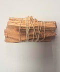 Five palo santo holy wood sticks tied with natural twine on white background — Fragrant Heaven Ireland