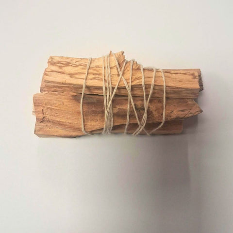Five palo santo holy wood sticks tied with natural twine on white background — Fragrant Heaven Ireland