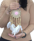 Pastel pink macramé dream catcher 9cm held in hand for size reference